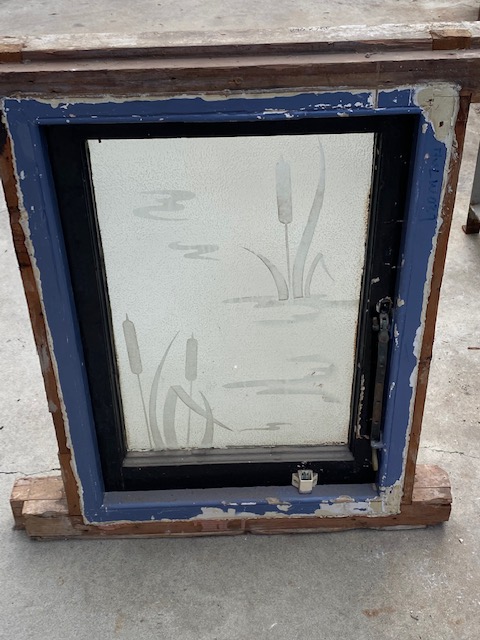 Etched glass window in frame